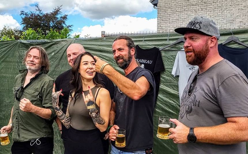 The band at the merch stand